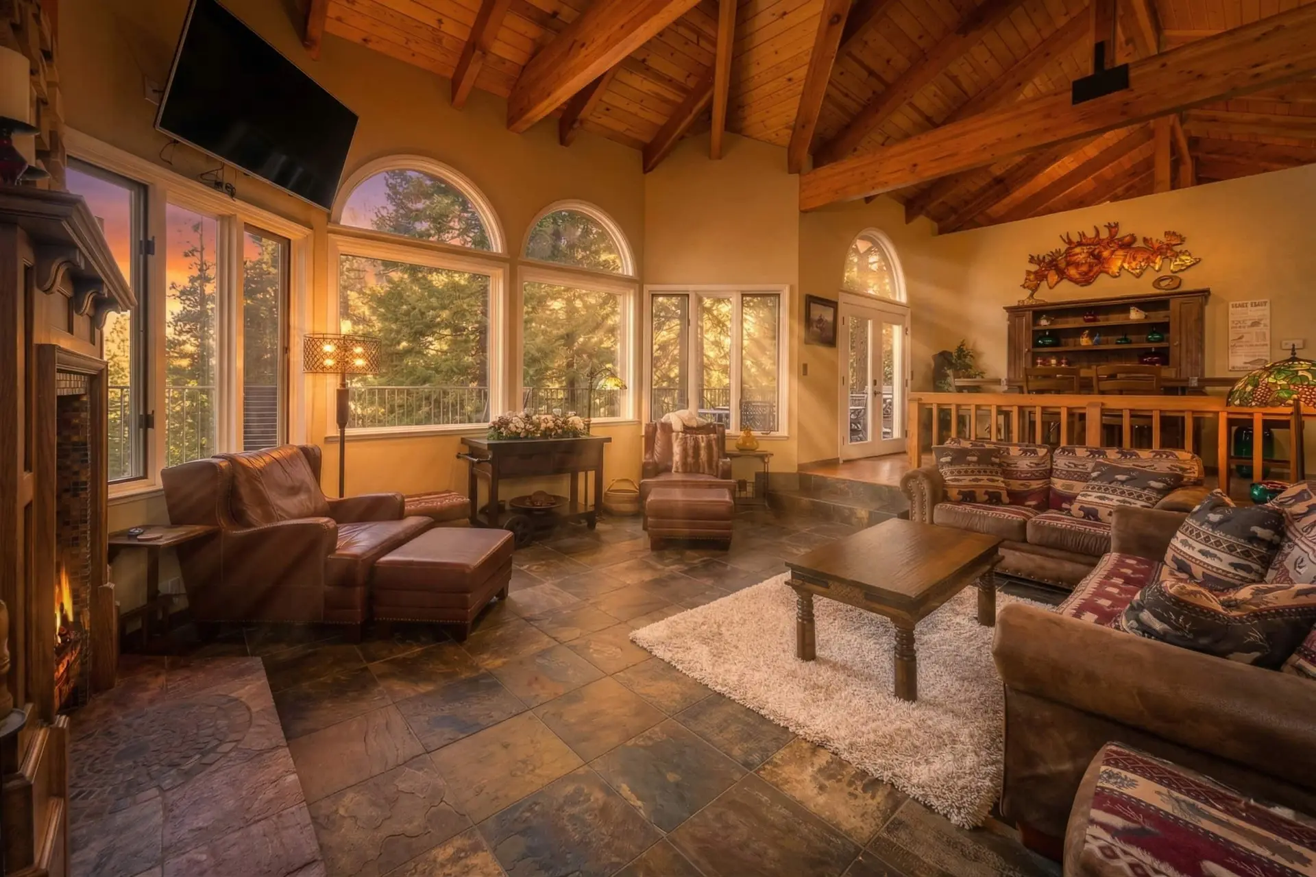 Living room with arched windows and leather couches, Dardanelle Retreat