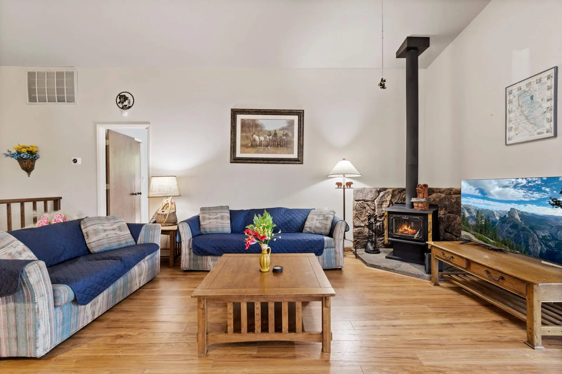 Living room with a wood stove and doors to the deck, Pine Mountain Lake Cabin